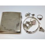 A mixed lot comprising a hallmarked silver cigarette case, hallmarked silver jewellery and white