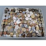 A tin ofassorted world coins.