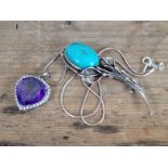 A purple paste and colourless stone pendant on chain both marked '925' and a white metal brooch