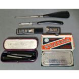 A tray of vintage razors and a button hook shoe horn to include a Taylor's cut throat razor (boxed),