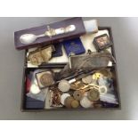 A box of assorted coins and bric a brac.