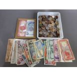 A tub of assorted world coins and banknotes.
