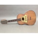 An Italian tortoiseshell inlaid mandolin guitar.