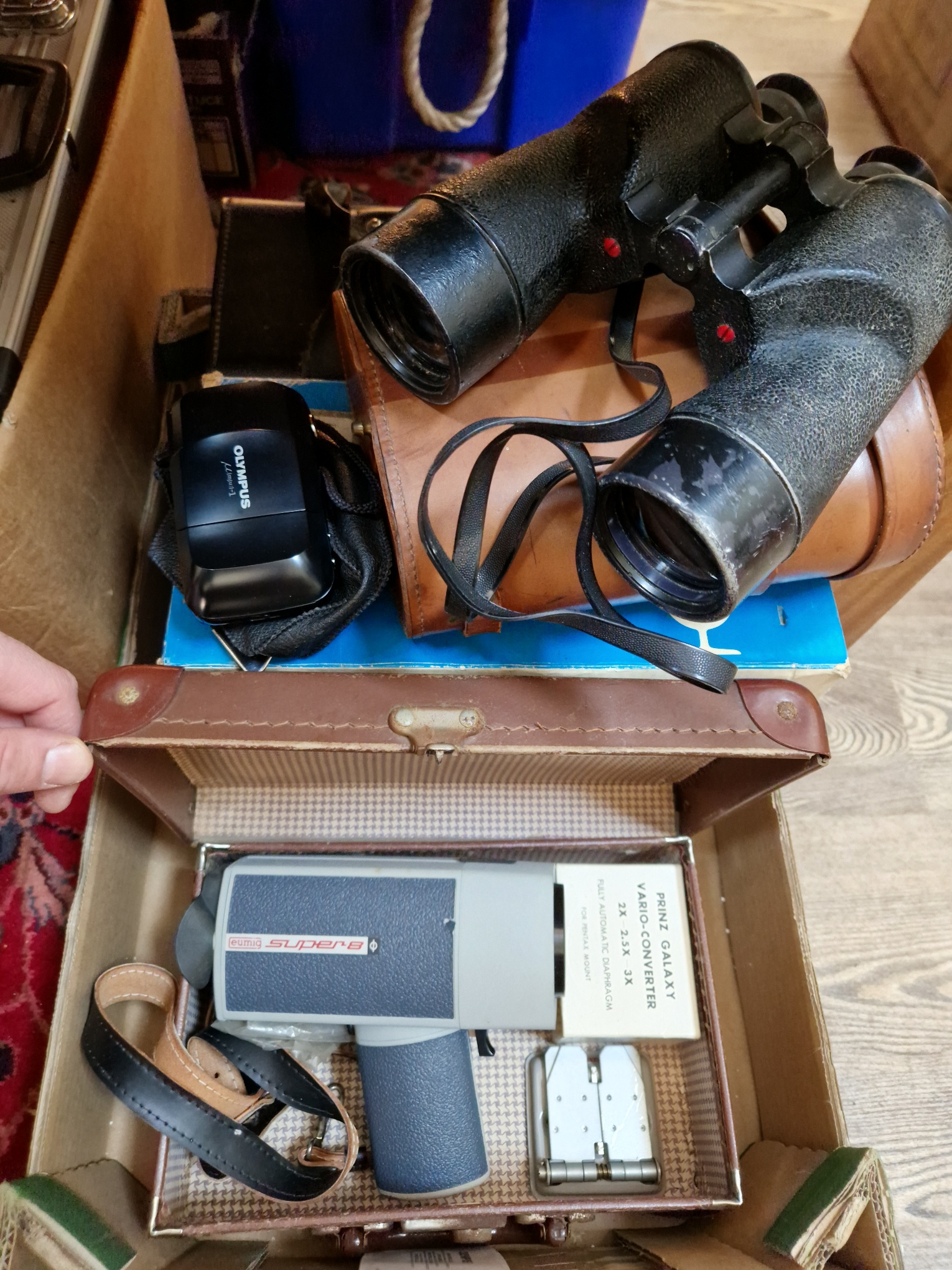 Assorted camera equipment comprising a Minolta X700 35mm camera, a pair of Canadian binoculars, a