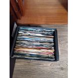 A box of vinyl singles including The Beatles, David Bowie, Soul, etc.