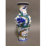 A Chinese porcelain vase, decorated in over enamels dragons and clouds, bearing six character