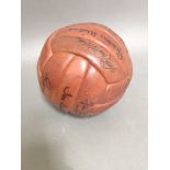 An autographed brown leather football, circa 1960s, ten Liverpool FC signatures comprising Ian