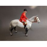 A Beswick pottery hunter on horse back, length 23cm. Condition - good, appears damage/repair free,