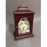 A Hermle mahogany cased mantle clock with moon phase dial, height 35cm.
