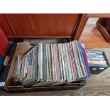 A collection of vinyl records, mostly 1970s/1980s rock and pop including The Beatles, David Bowie,