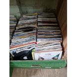 A box of approx. 200 45s, various dates and genres.