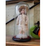 A Limoges Cherie porcelain doll with composition body and jointed limbs, under glass dome.