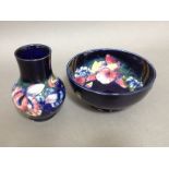 Two pieces of Moorcroft pottery, bowl diam. 15.5cm, vase height 12.5cm. Condition - bowl with