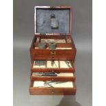 A 19th century mahogany dentist's cabinet with assorted contents.