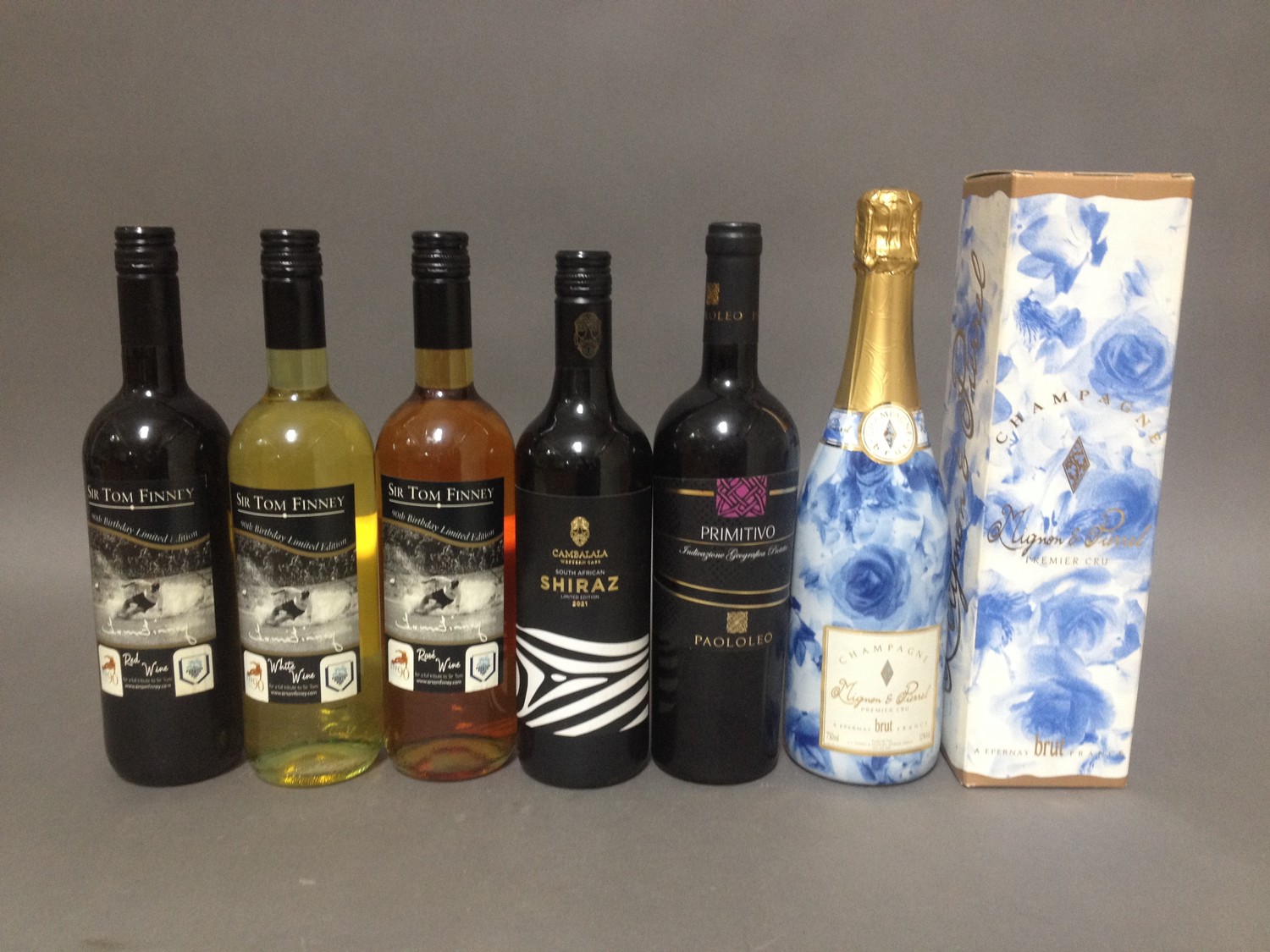 Various wines and champagne including a set of three Tom Finney limited edition wines and a bottle