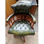 A green leather captains chair