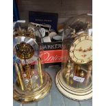 A box of assorted Royal commemorative pottery and glass and two domed mantle clocks.