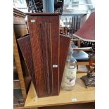 An Art Deco oak umbrella stand together with large whisky bottle.