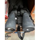 A pair of cased binoculars 108x70