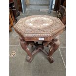 A carved wood elephant table, inlaid to top, circa 1900.