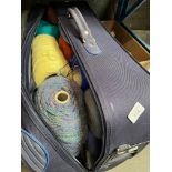 A suitcase of machine knitting wool.