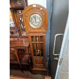 A 1930s oak cased granddaughter clock.