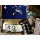 A tin of mixed costume jewellery and watches including silver etc.