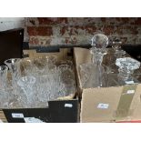 Two boxes of glassware to include 5 decanters, various vases, a jug, drinking glasses, etc.