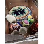 A box of various ceramic items including a Majolica bread plate, a pair of 1922 Preston Guilt