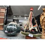 A vintage wooden carousel and a studio pottery vase.