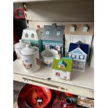 A box of ornamental cottages and kitchen jars including Boulevard, Kirstie, At Home with Ashley