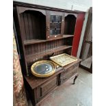 An Edwardian Arts and Crafts oak dresser with leaded glass panel to the top.