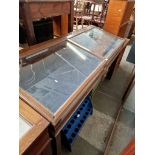 A large glazed mahogany display table with interior lights.