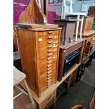 Various items of furniture; an oak desk, a set of vintage oak filing drawers, a pitch pine wall