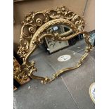 Two ornate gilt framed mirrors.