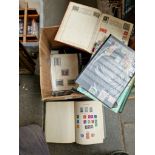 A box of stamp albums and loose stamps