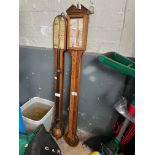 A Comitti stick barometer and a Meyer & Co stick barometer.
