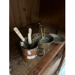 A Victorian brass warming pan, a set of graduated brass and copper pots and a brass mug.