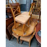 A Bevan Funnell Reprodux yew wood Regency style dining table and six chairs, the chairs having suede