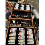 An artists cantilever box containing oil paints, acrylics, watercolours, pastels, coloured pencils