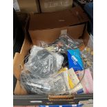 A box of guitar and banjo accessories to include strings, tuners and a practice amplifier etc.