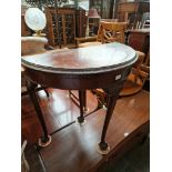 An early 20th century mahogany demi-lune card table on ball and claw feet.