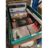 A box of military related books and 1950s magazines.