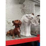 A ceramic elephant vase and a ceramic dachshund.