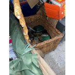 A wicker fishing box with contents including reels, etc together with some fishing tackle.