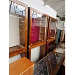 A pair of large glazed mahogany display cabinets with interior lights.