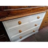 A painted pine chest of drawers.