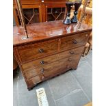 A Victorian inlaid mahogany chest of drawers, standing on bracket feet.