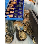 A box of metal-ware, horse brasses, rabbit door stop, brass animals, etc