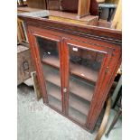 A pine church pew together with a Victorian glazed mahogany bookcase.
